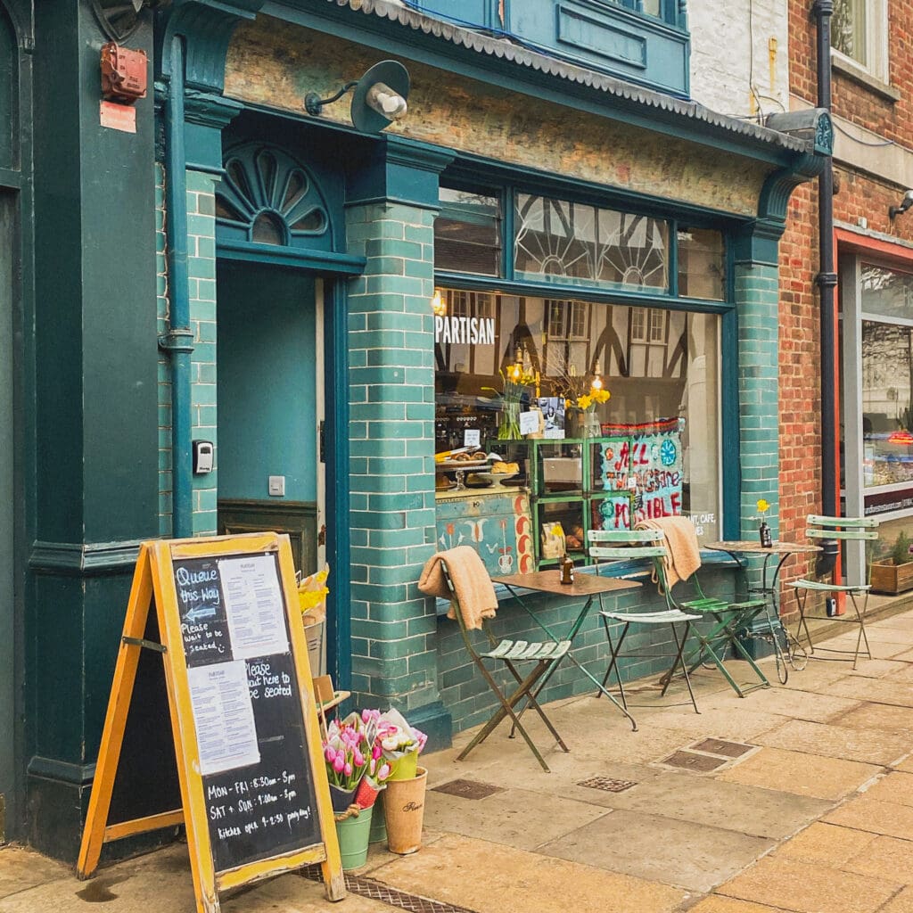 Partisan Cafe in York, UK with tulips and cafe tables out front